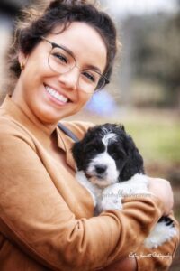 woman with glasses smiling with her dog