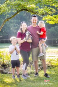 a happy family with their newly adopted aussiedoodle